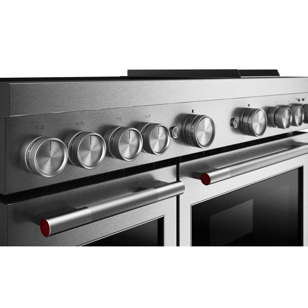 Close-up of stainless steel range control panel with six round knobs and dual oven handles in kitchen appliances collection