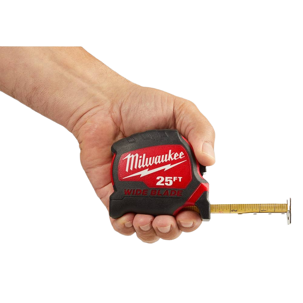Hand gripping Milwaukee measuring tape with 25-foot wide blade extended, used for precise home improvement measurements