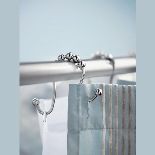 Set of polished chrome shower curtain hooks with smooth rolling beads on metal rod for home improvement use
