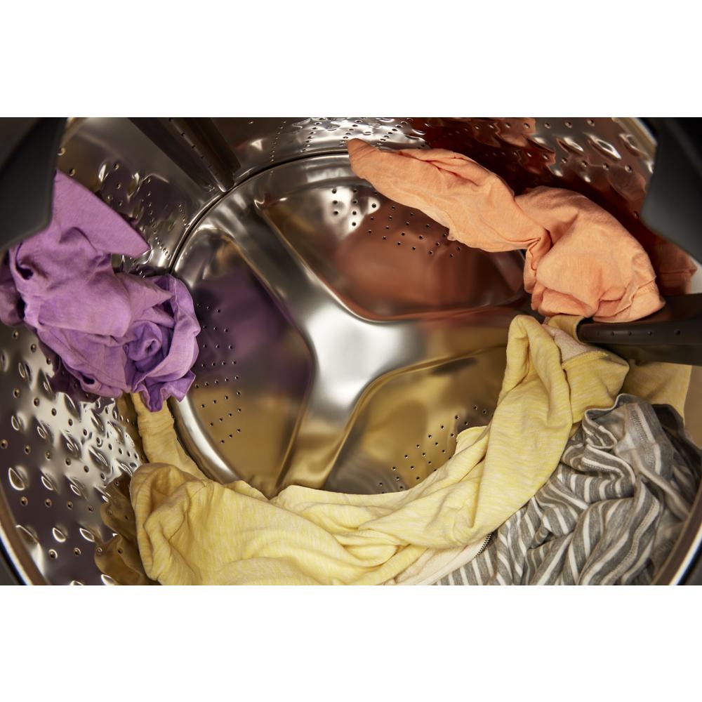 Top-down view of colorful wet clothes inside a stainless steel drum of a ventless washer dryer combo in appliances collection