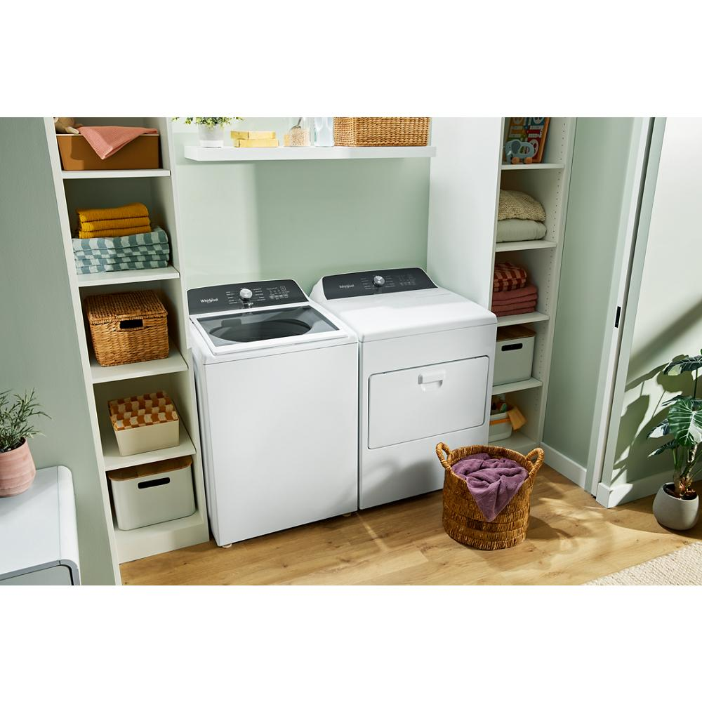 Whirlpool white top load washer and matching dryer set in laundry room with shelves and wicker basket for home appliances