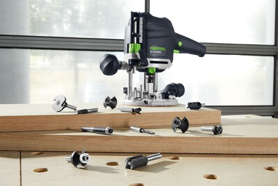 Festool router positioned on wood with various router bits displayed for precision woodworking and home improvement tasks