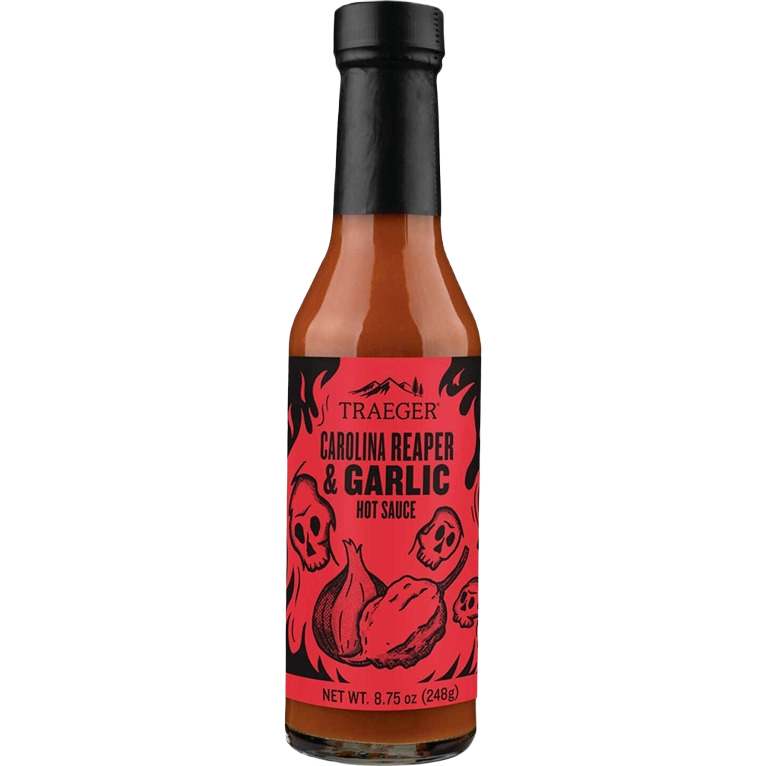 Bottle of Traeger Carolina Reaper and garlic hot sauce with red label featuring skulls and flames design