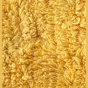 Close-up of yellow cotton chenille fabric with textured shaggy loops for absorbent kitchen towel use under $50 collections