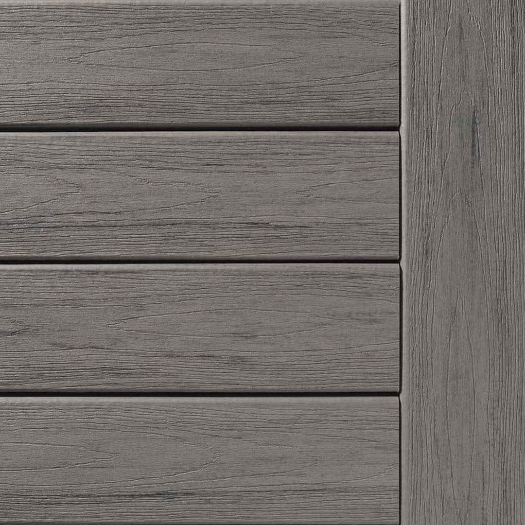 Grooved composite deck boards in driftwood color with textured woodgrain finish for home improvement projects