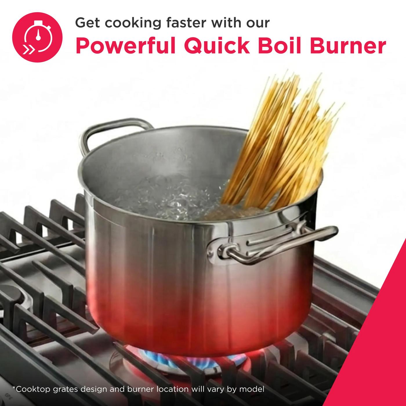Stainless steel pot boiling pasta on burner of gas cooktop with quick boil feature in kitchen setting