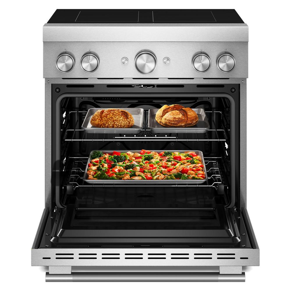 Stainless steel commercial-style induction range with four elements and open oven showing air-fried food inside