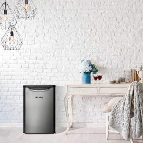 Energy-efficient compact refrigerator with brushed stainless steel door in a stylish modern kitchen setting