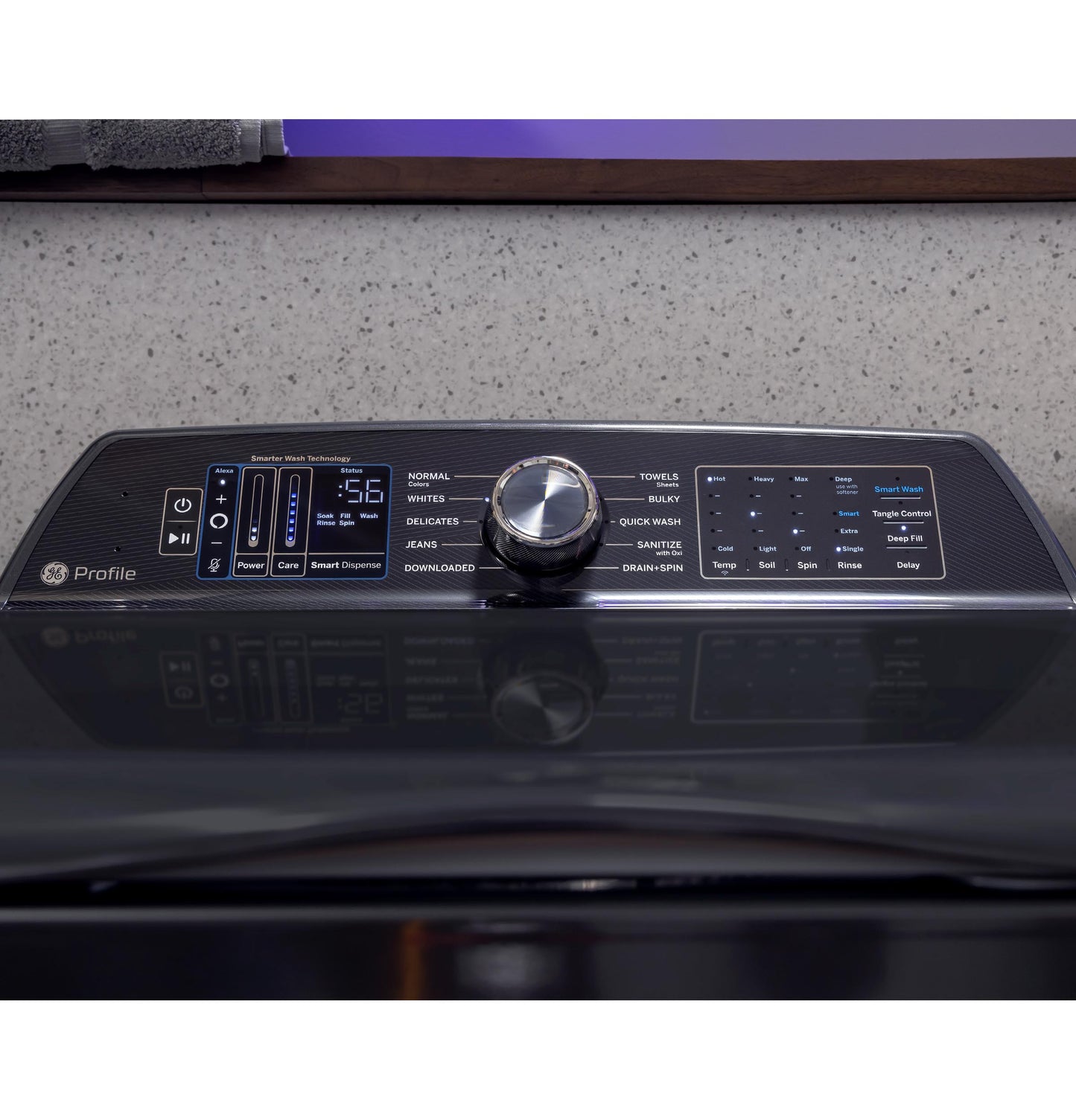 Control panel close-up on black top load washer highlighting cycle options and digital display in appliance setting