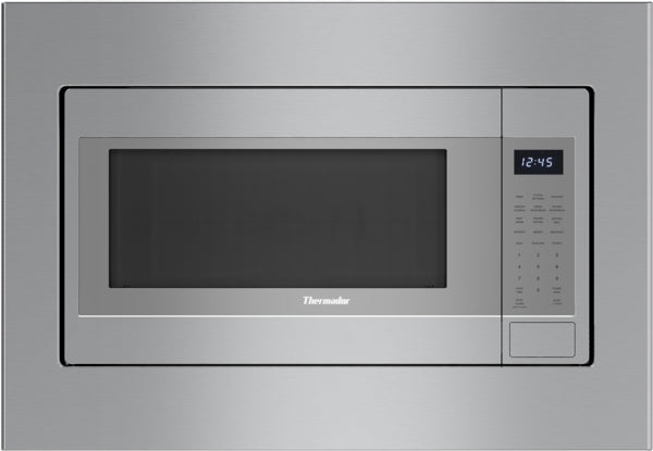 Built-in stainless steel microwave with digital control panel and left side opening door, integrated into kitchen cabinetry