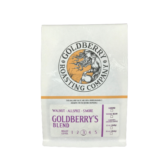 White bag of Goldberry's Blend ground coffee with a circular logo featuring a sun and woman, marked roast level 3/5