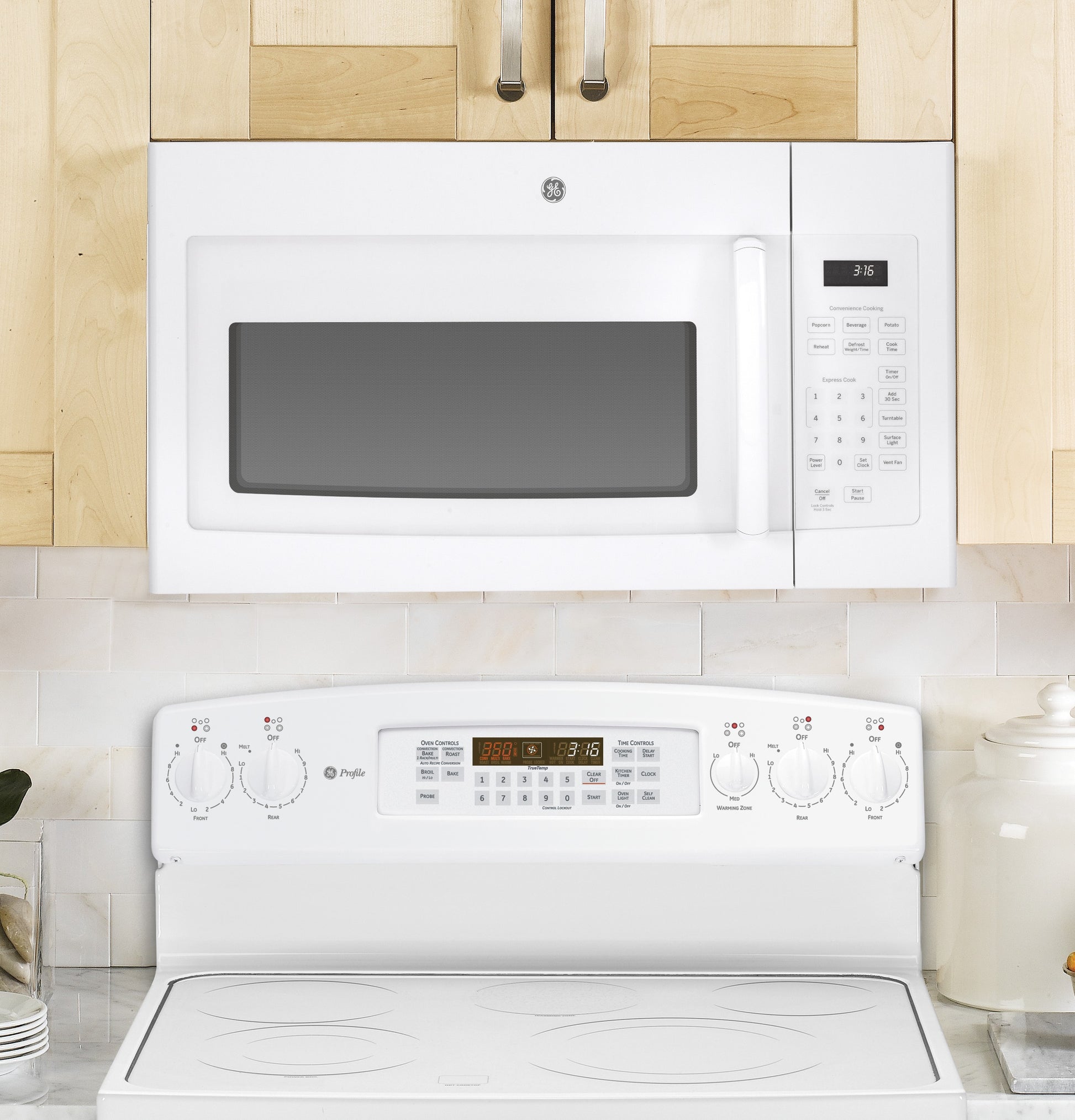 White over-the-range microwave with digital keypad above white electric stove in kitchen and appliances collection