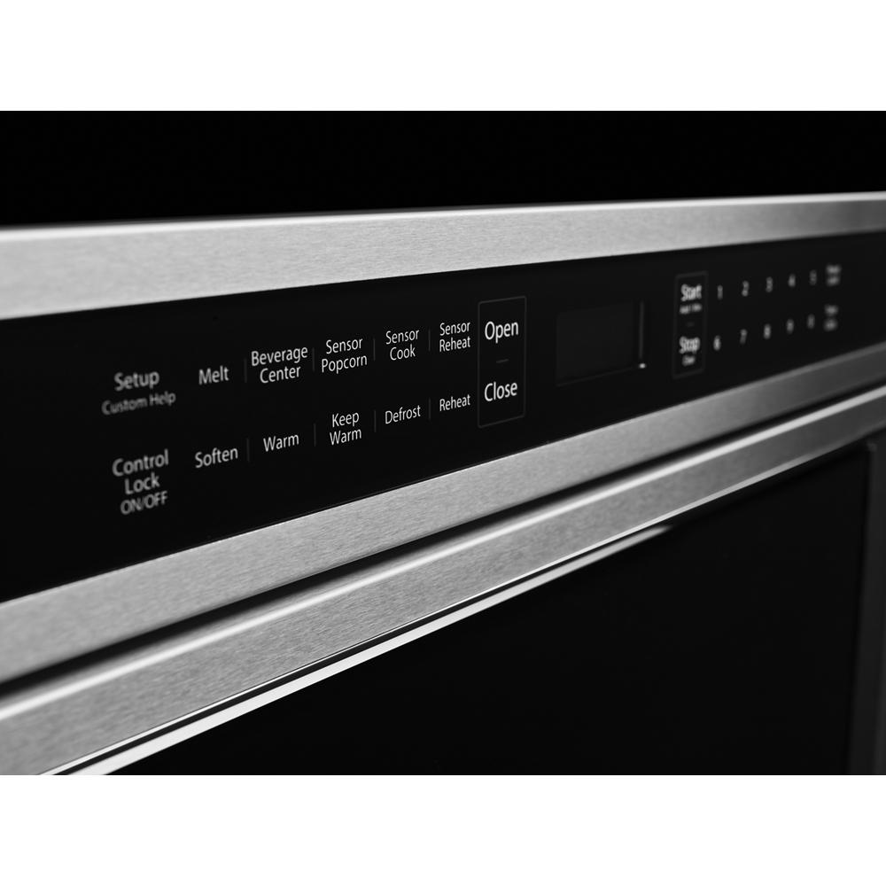 Close-up of stainless steel microwave drawer control panel with digital touch buttons for cooking functions and settings