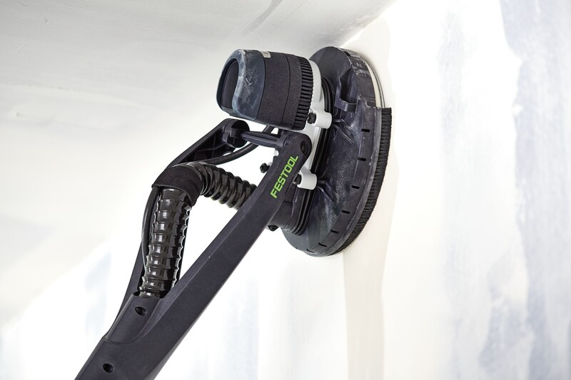 Black and white power sander with branded grip smoothing a drywall corner for home improvement tasks