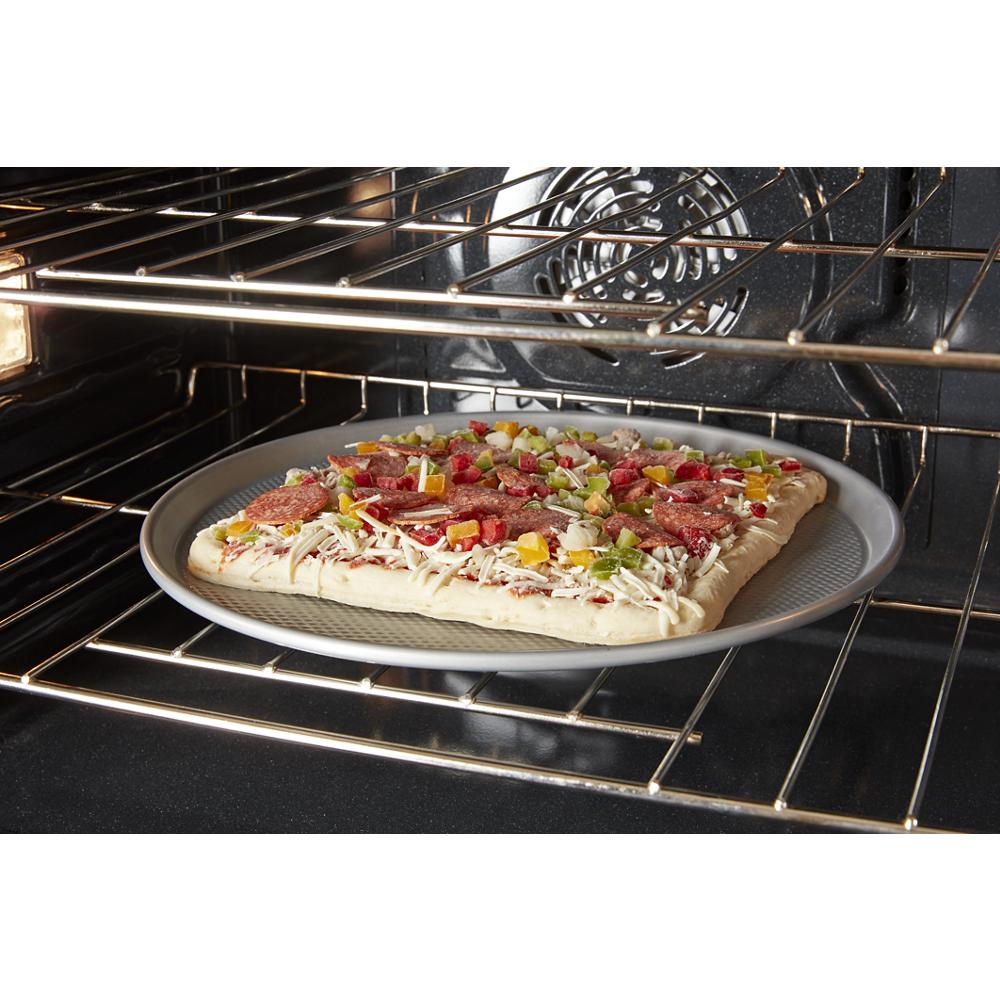 Uncooked rectangular pizza with toppings inside a single wall oven from Kitchen & Kitchenware collection