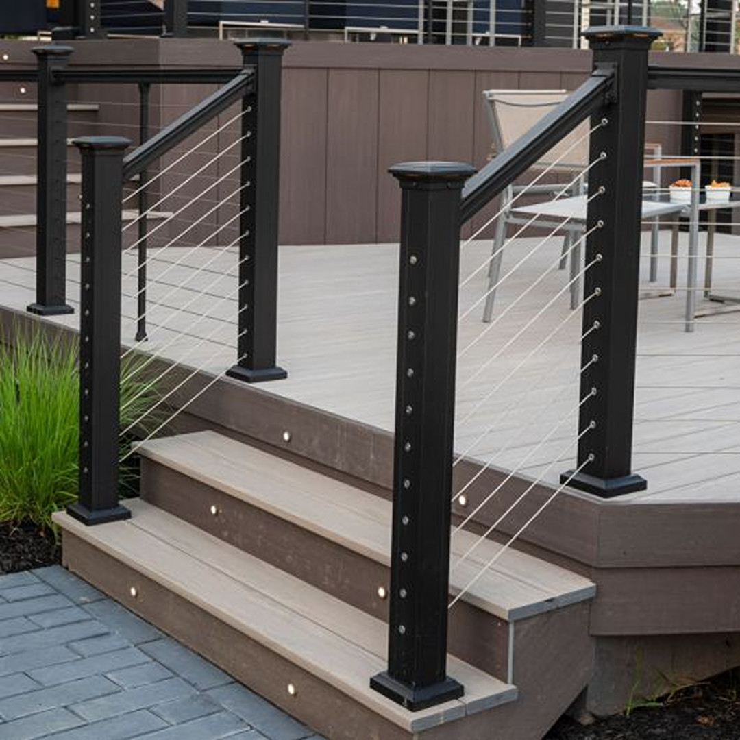 Modern black stair railing with horizontal cable design installed on outdoor deck steps for home improvement