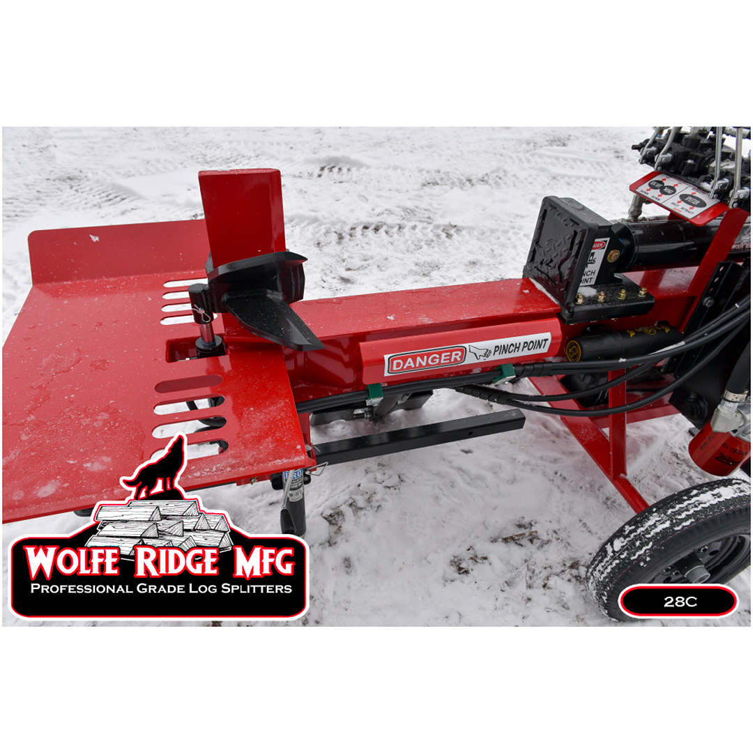 Close-up of red Wolfe Ridge log splitter beam and wedge with danger label on snowy ground outdoors