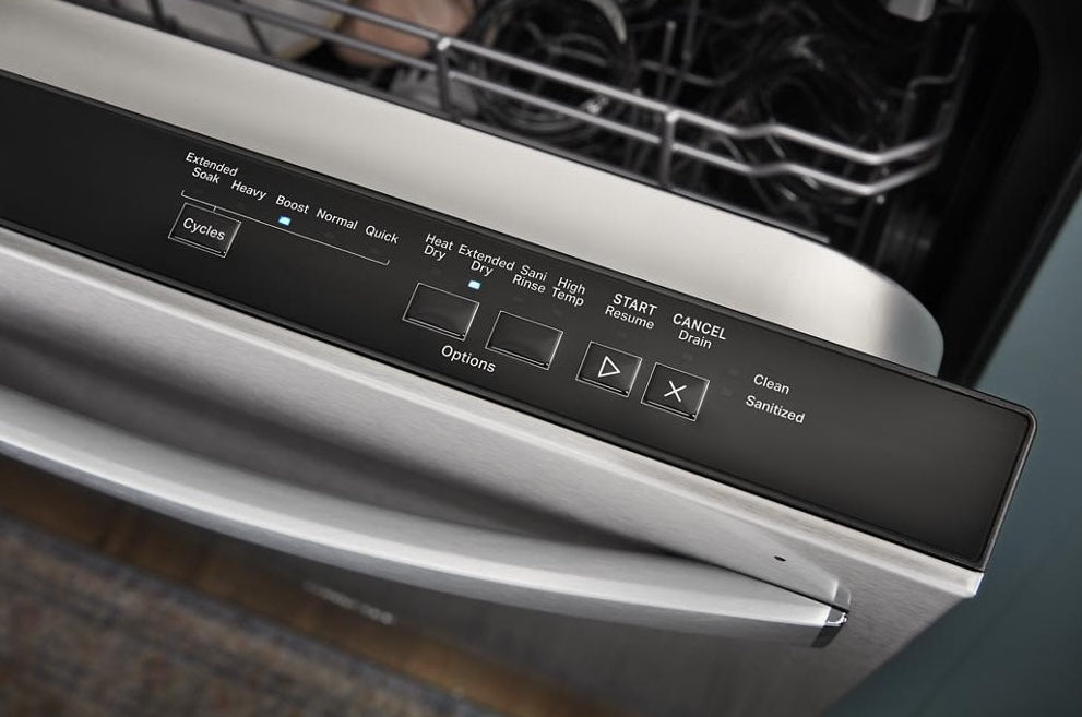 Close-up of stainless steel dishwasher control panel showing cycle and option buttons for kitchen appliances.