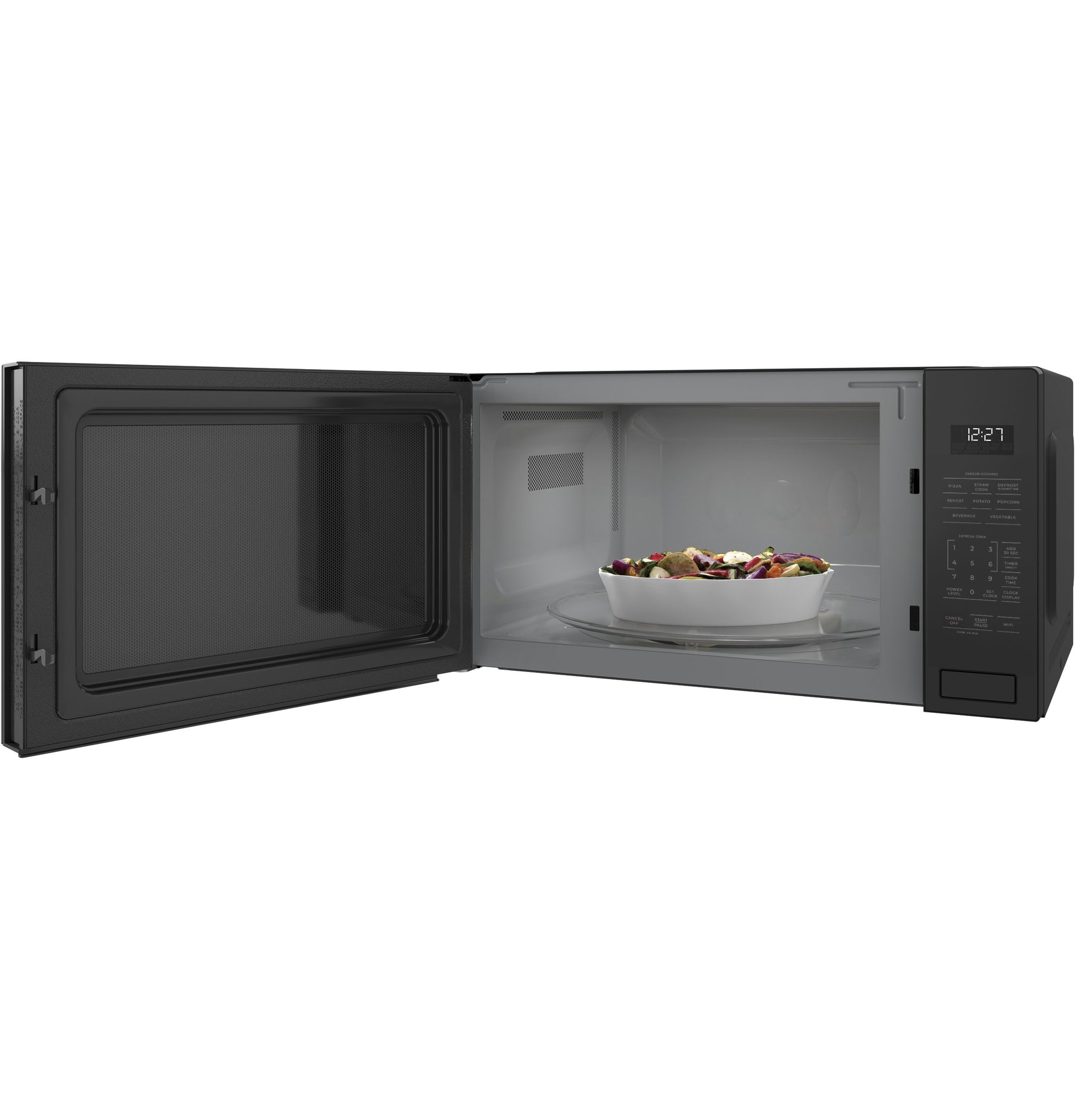 Black built-in microwave with open door revealing white interior and bowl of mixed vegetables inside kitchen appliance collection
