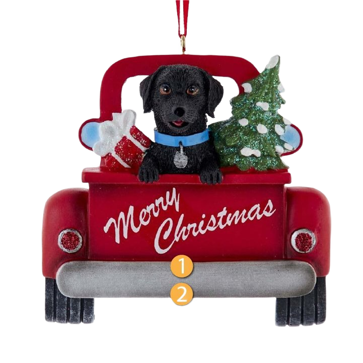 Black Labrador sitting in red truck with Christmas tree and gifts, festive holiday decoration under $50.