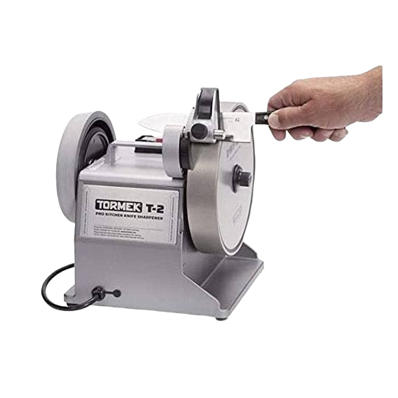 Electric kitchen knife sharpener with coarse grinding wheel and hand guiding a knife for precision sharpening.