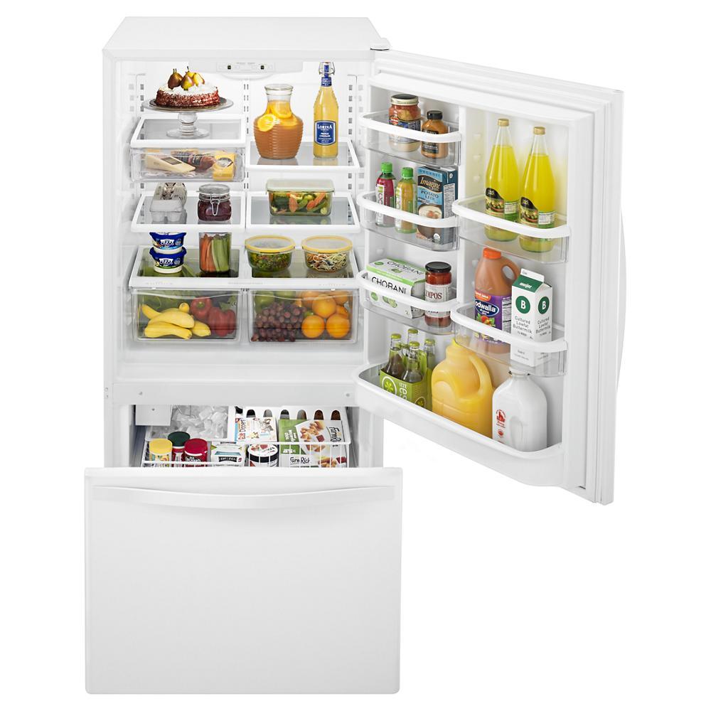 White bottom-freezer refrigerator with SpillGuard™ glass shelves, stocked with food, in Refrigerators and Kitchen & Kitchenware collections