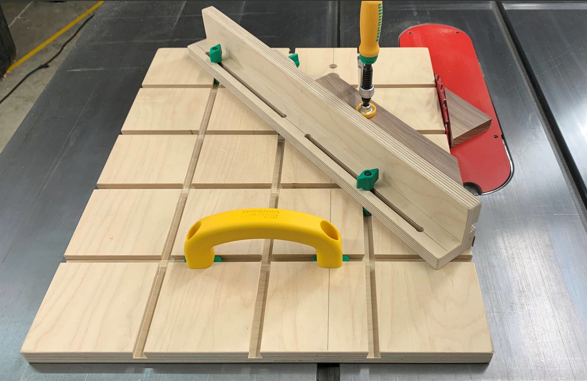 Light wood Microjig MatchFit jig handle with green clips and yellow grip for precision woodworking and home improvement tasks