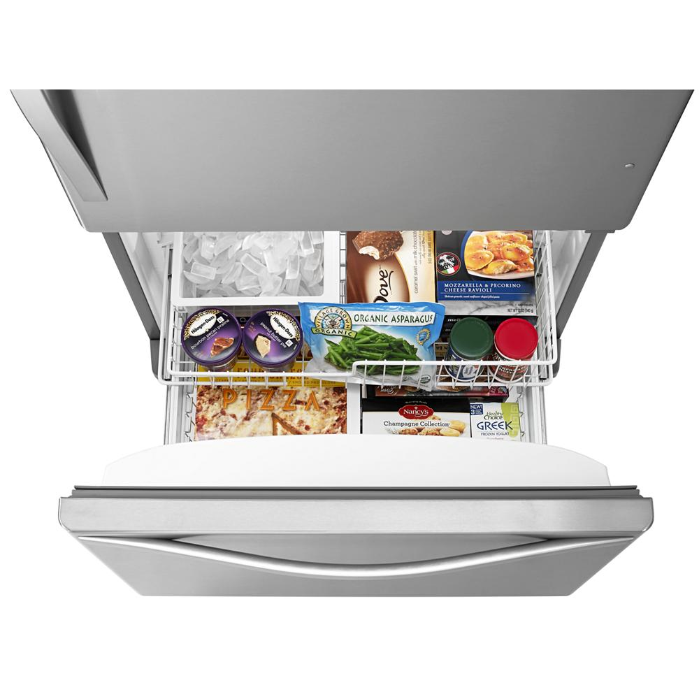 Open bottom-freezer drawer with organized frozen foods and ice storage in stainless steel kitchen appliance collection