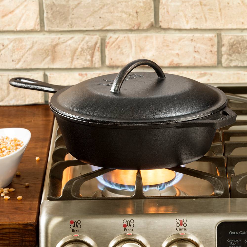 Extra deep cast iron chicken fryer with lid and handle on lit gas stove in kitchenware and Lodge Cast Iron collections