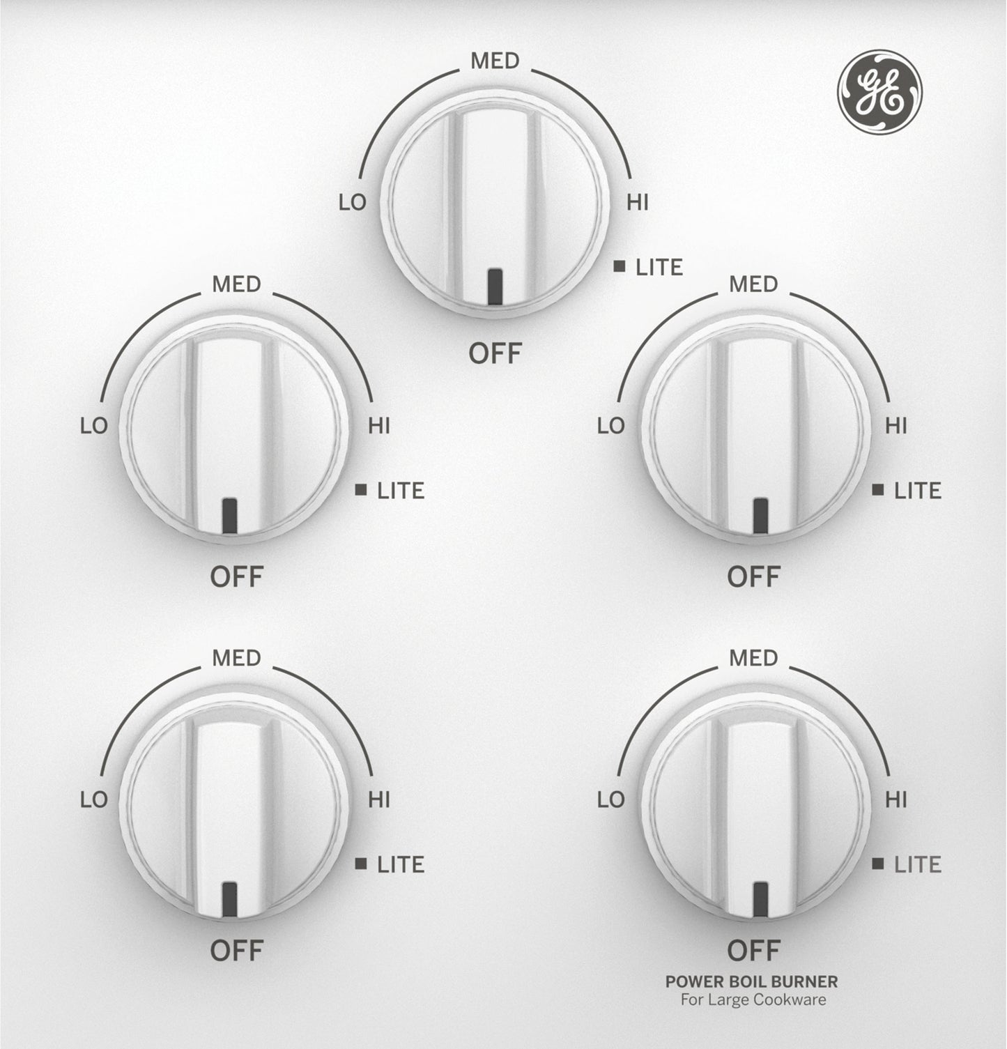 Close-up of white gas cooktop control panel with five knobs and GE logo from kitchen appliances collection