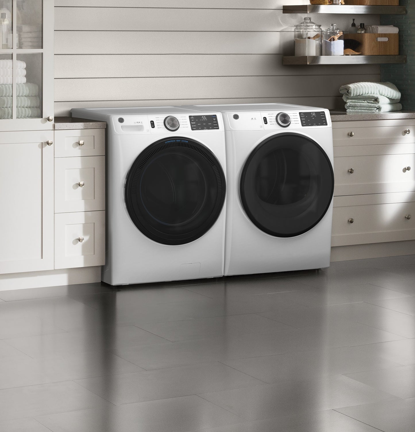 White front load washer and dryer set with digital controls in a bright modern laundry room from washers and dryers collection