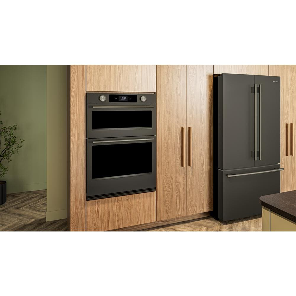 Built-in black ore double wall oven with LED control panel and backlit knobs installed in modern wood cabinetry kitchen