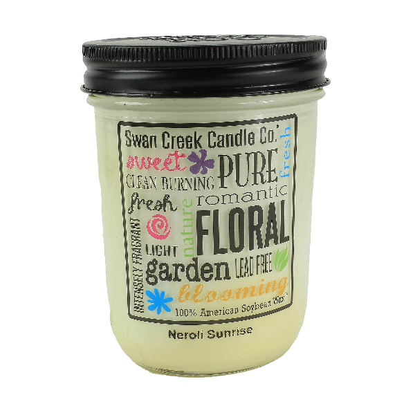 Glass jar candle with black lid featuring colorful floral and text design highlighting natural soy wax and fresh floral scent