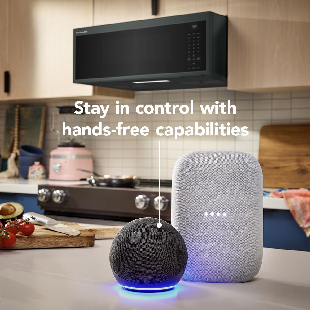 Modern black over-the-range microwave hood with smart speakers on kitchen counter for home improvement and appliances