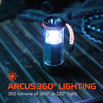 Compact black and silver lantern with orange paracord strap emitting bright 360-degree light for woodworking tools and home improvement