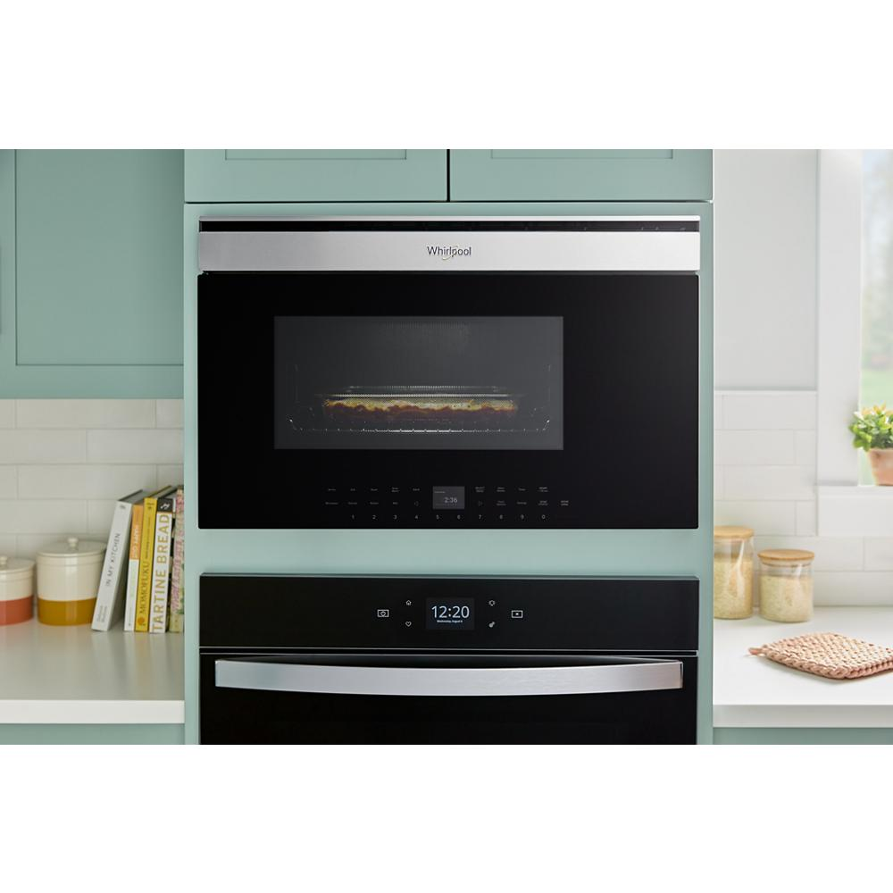 Built-in smart microwave with air fry function and sleek stainless steel handle integrated in modern kitchen cabinetry