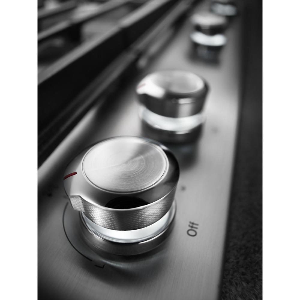 Close-up of stainless steel control knobs on a modern cooktop from Cooktops and Kitchen & Kitchenware collections