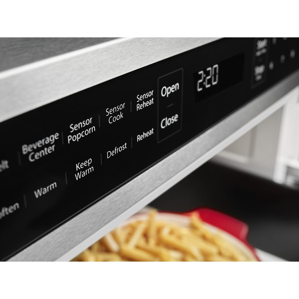 Close-up of digital control panel on stainless steel microwave drawer with preset cooking options and timer display