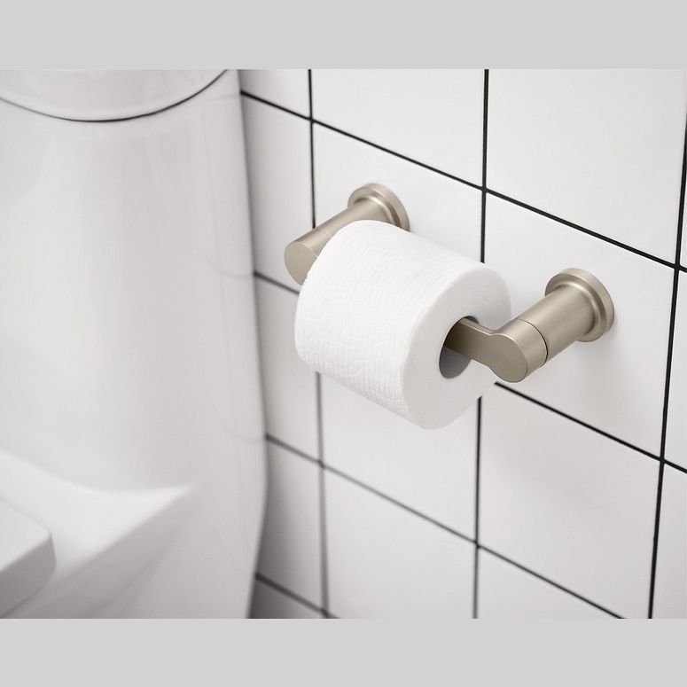 Brushed nickel pivoting toilet paper holder mounted on tiled wall near white toilet for home improvement