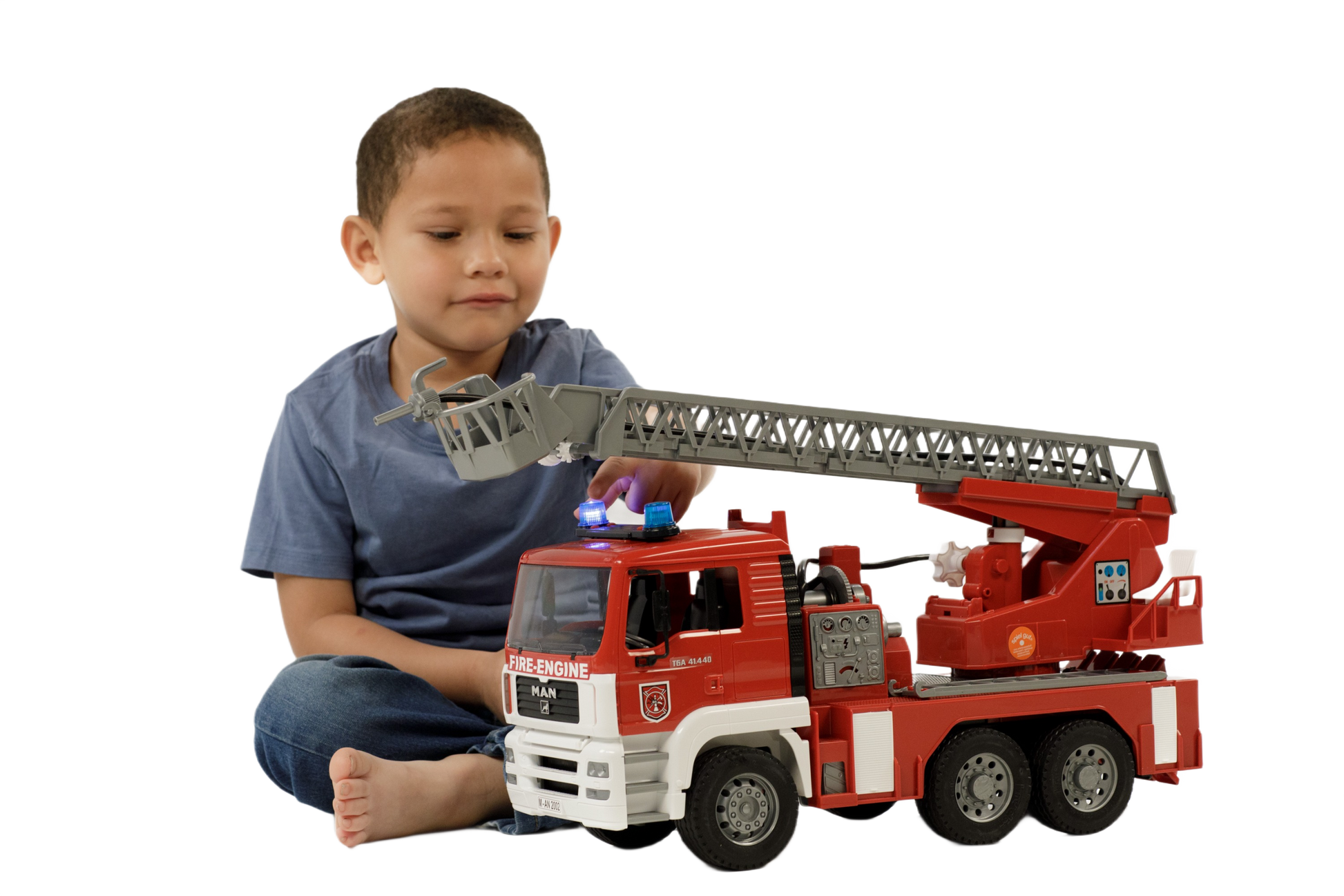 Child playing with detailed red and white toy fire engine featuring ladder, water pump, lights, and sounds from Bruder Toys collection