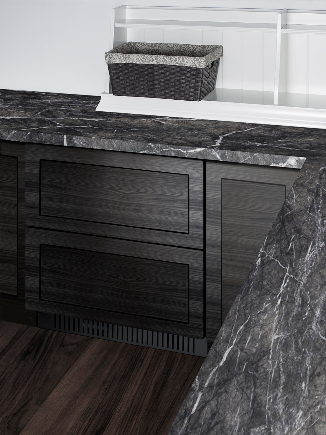 Built-in undercounter 27-inch 2-drawer refrigerator with dark wood panels and black marble countertops in kitchen setting
