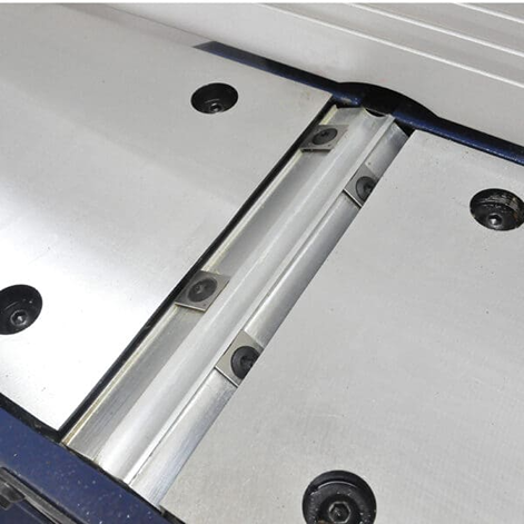 Close-up of a benchtop jointer’s cutter head insert and precision-machined metal surfaces for woodworking tasks