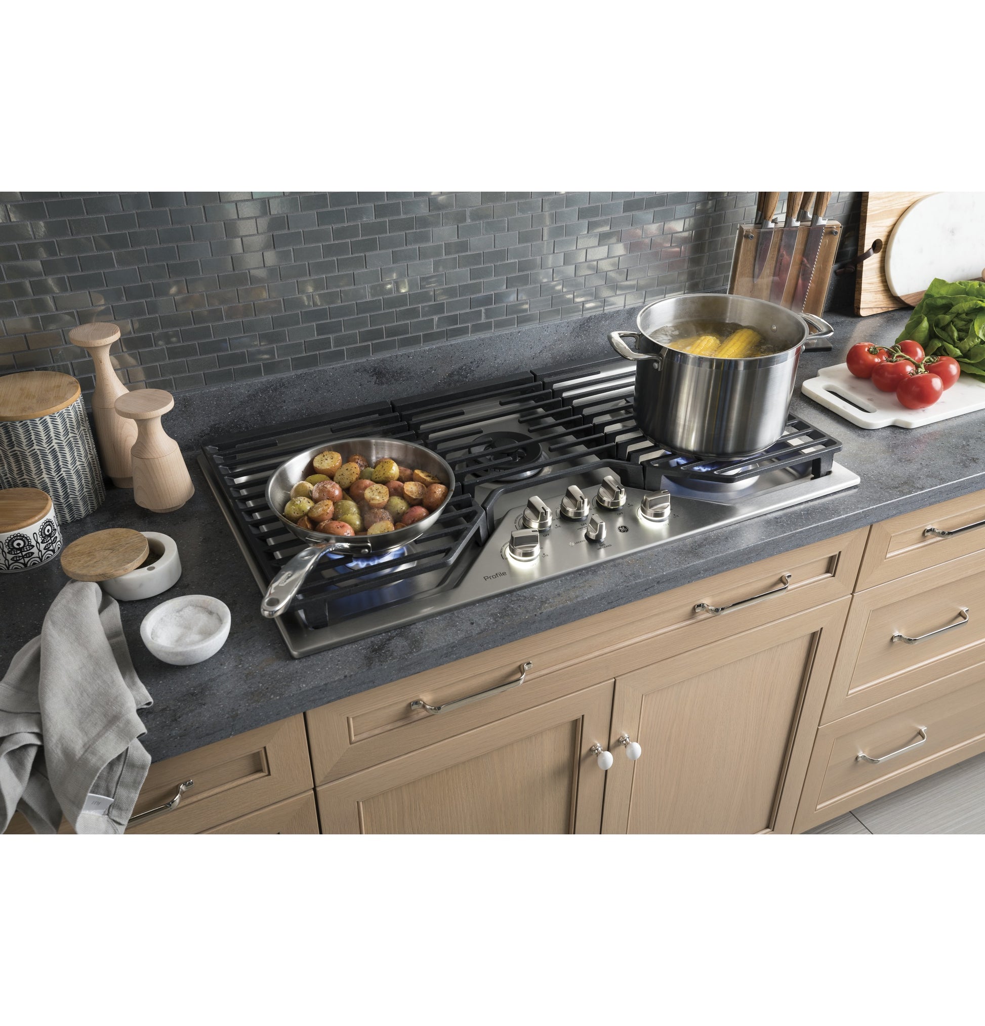 Built-in stainless steel gas cooktop with five burners and extra-large integrated griddle in kitchenware collection