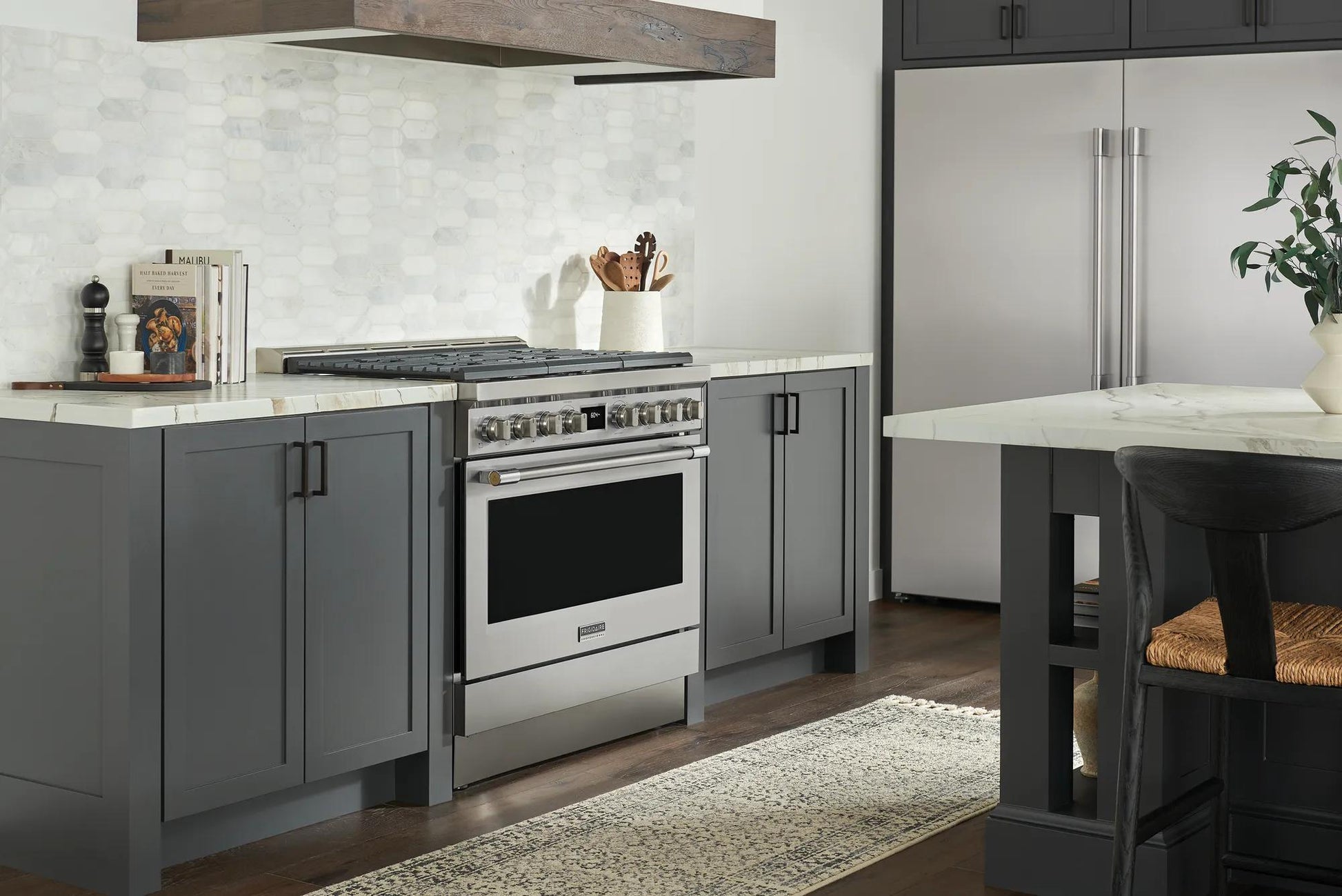 Kitchen featuring a stainless steel six-burner dual-fuel range with gray cabinetry and modern appliances in a home improvement setting