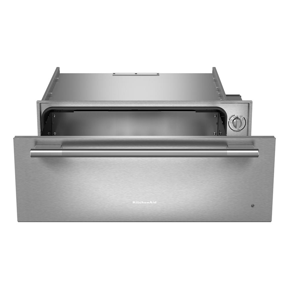 Stainless steel warming drawer with control knob open for slow cooking and food warming in kitchen appliances category