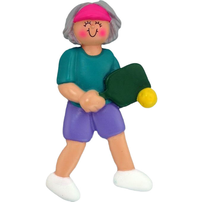 Gray-haired female figurine wearing pink visor and teal shirt holding green pickleball paddle and yellow ball ornament