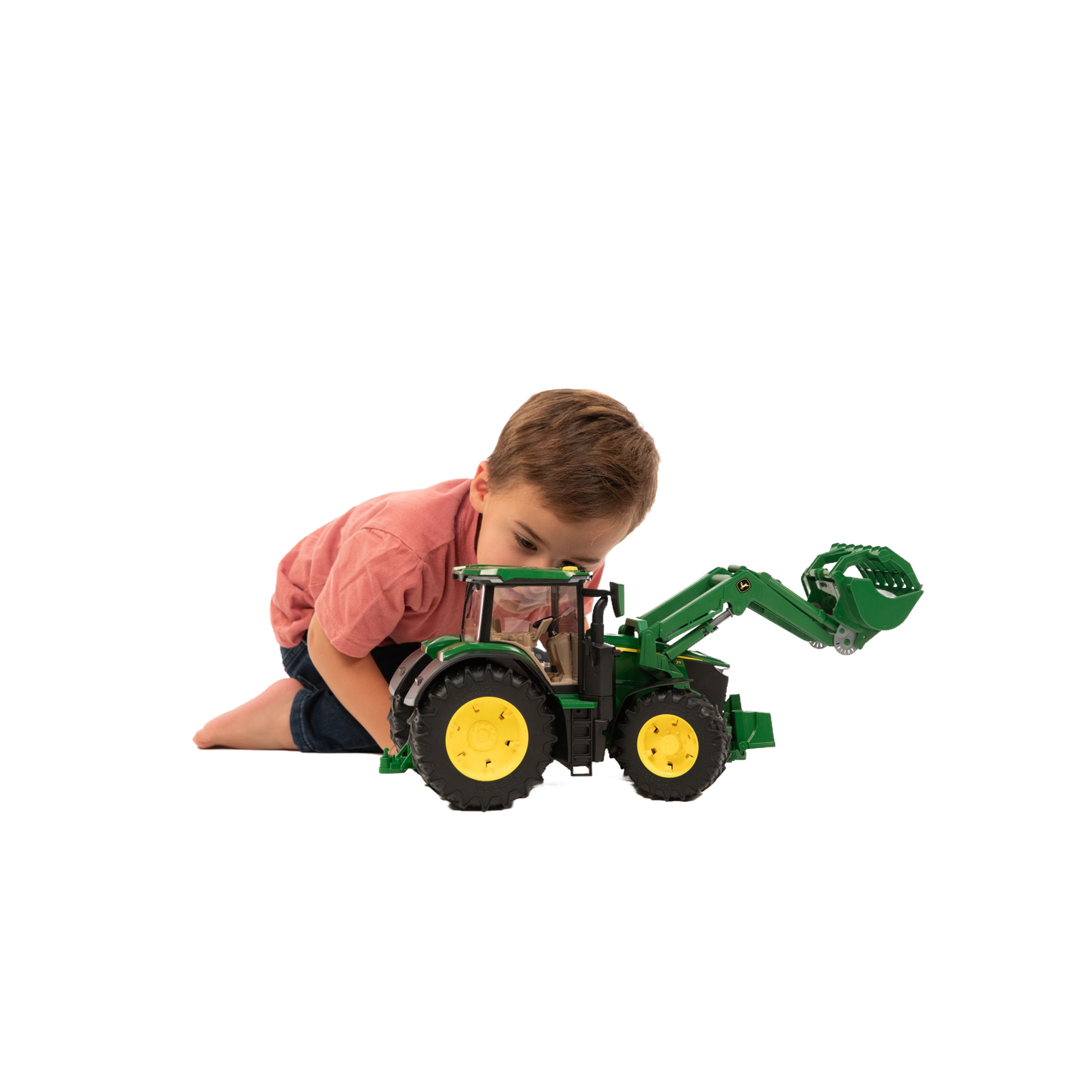 Child playing with green toy tractor with front loader and yellow wheels from Vehicles & Remote Controlled Toys collection