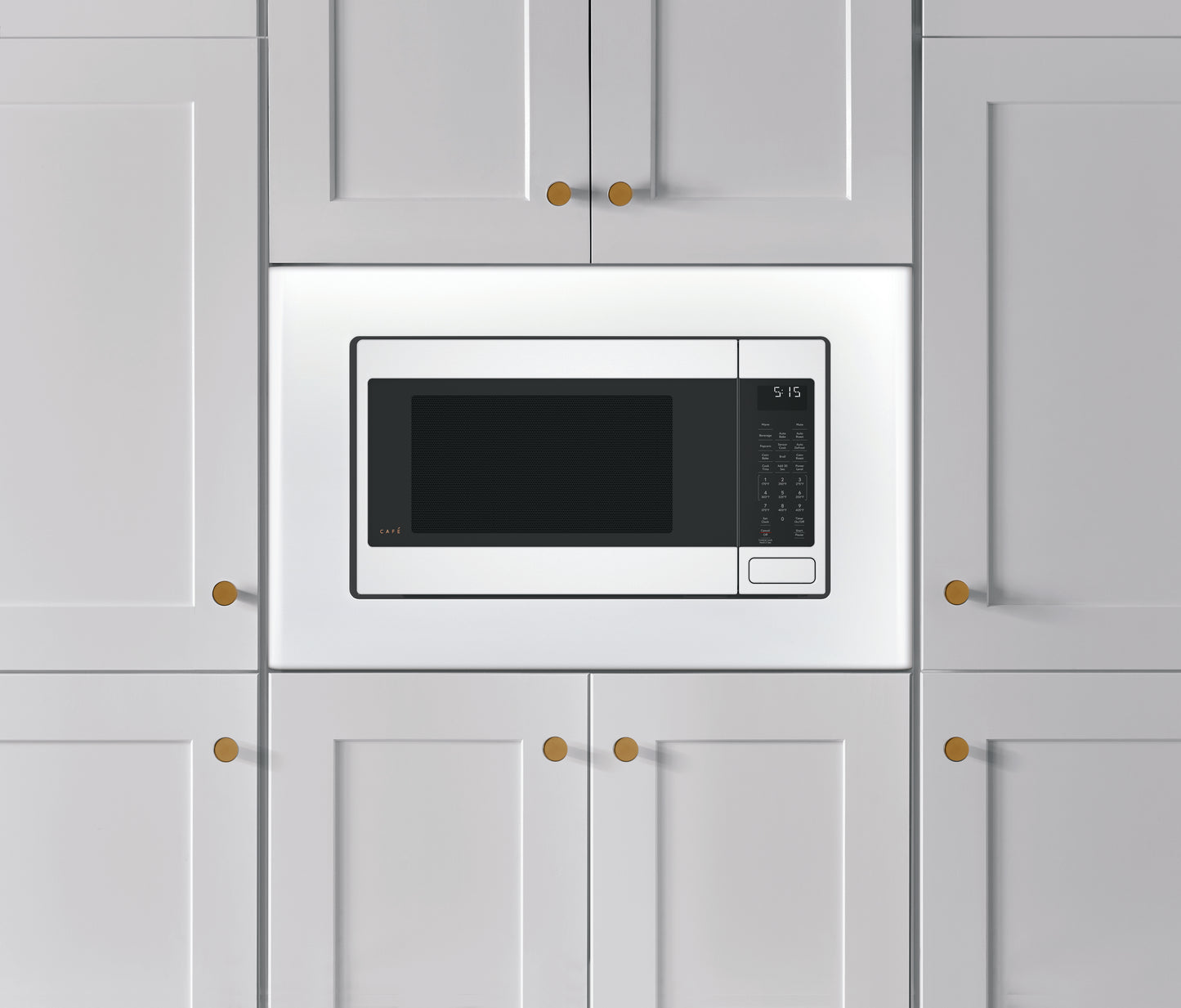 Built-in white smart countertop microwave with digital controls, surrounded by white cabinetry from Kitchen & Kitchenware collection