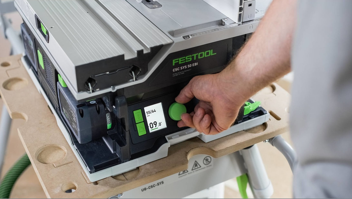 Close-up of a Festool cordless table saw with digital display and adjustment knob on a portable workbench in a workshop setting