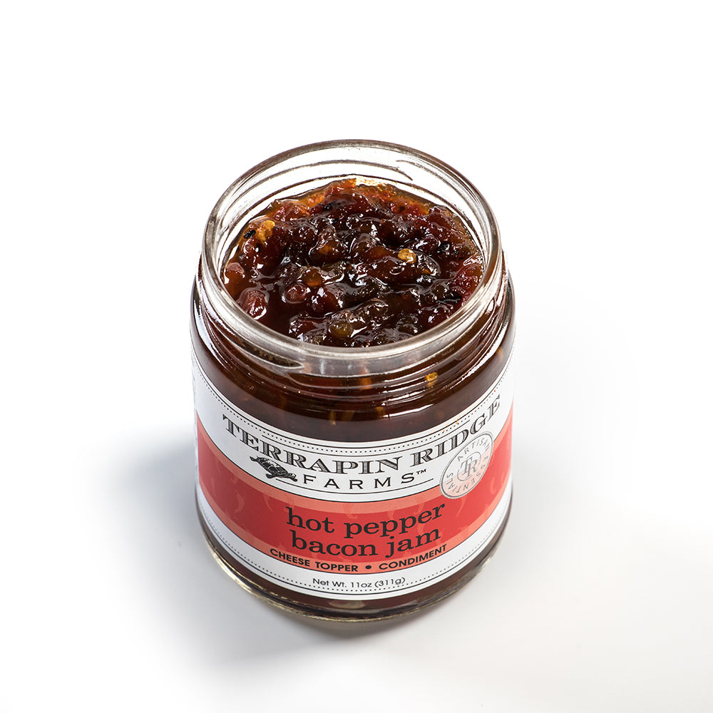 Open jar of spicy hot pepper bacon jam with visible bacon bits and glossy texture in Food & Beverage collection
